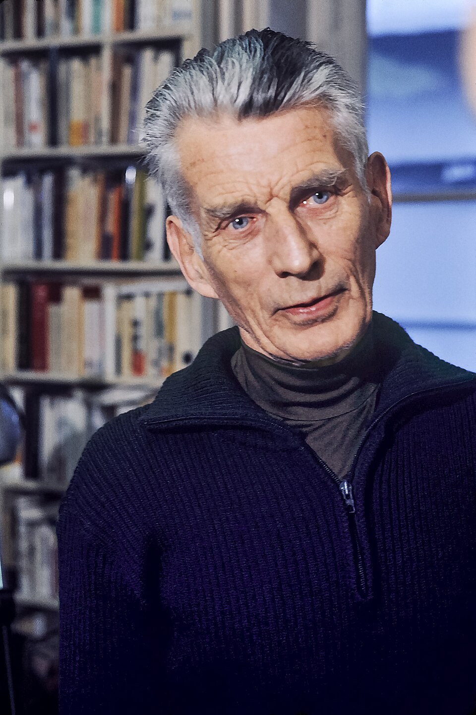 Samuel Beckett in 1977, seated, looking to camera.