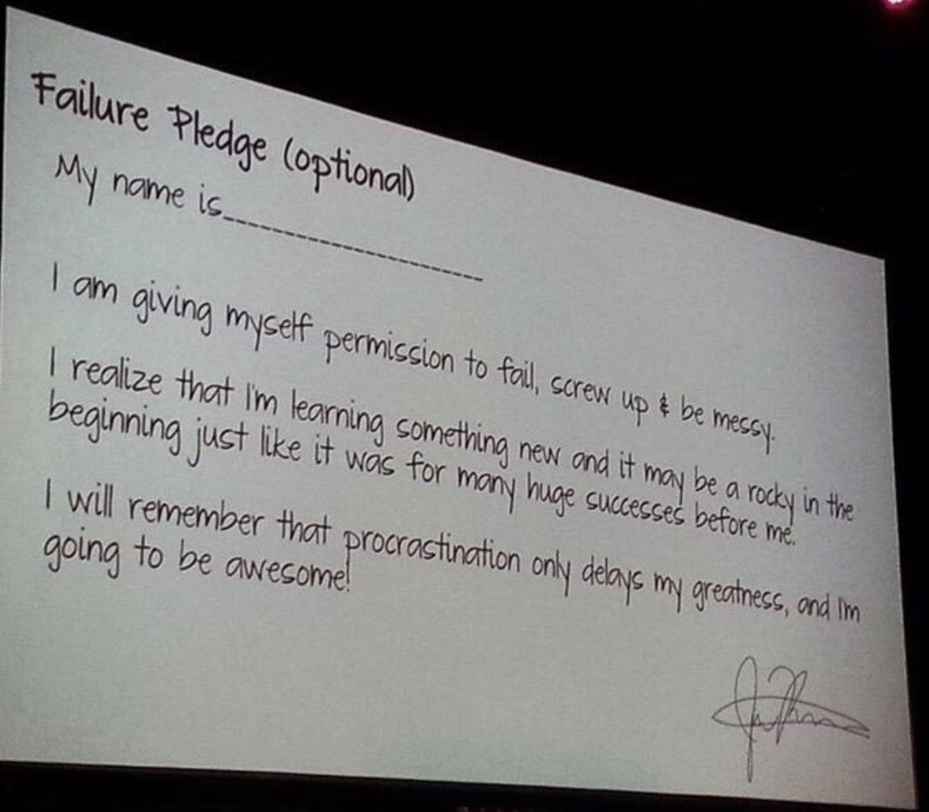 The Failure Pledge projected on a screen: a handwritten-style slide headed Failure Pledge (optional), with a blank name line, the three lines of the pledge, and a signature at the foot.